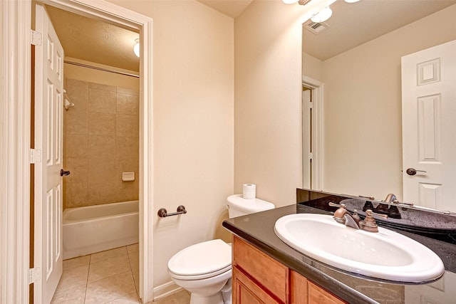 full bathroom with tile patterned floors, toilet, tiled shower / bath combo, and vanity