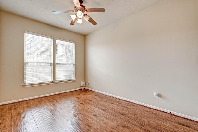 spare room featuring ceiling fan, a textured ceiling, and light wood-type flooring