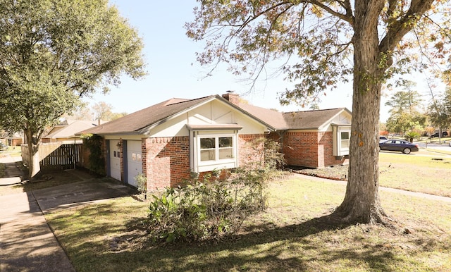 ranch-style home with a garage and a front yard