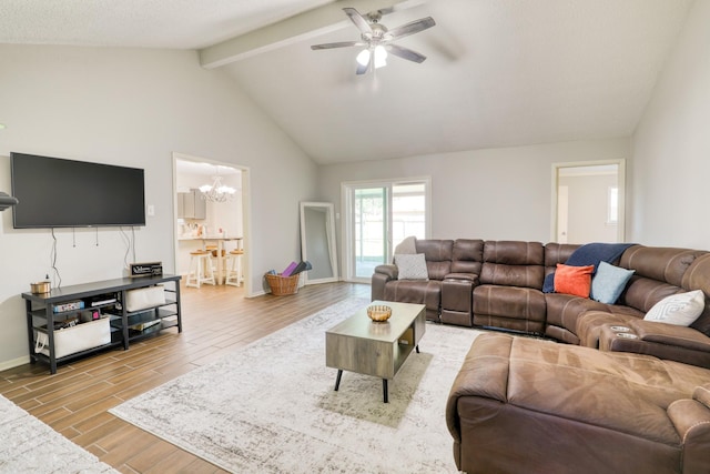 living room with ceiling fan with notable chandelier, lofted ceiling with beams, and a textured ceiling