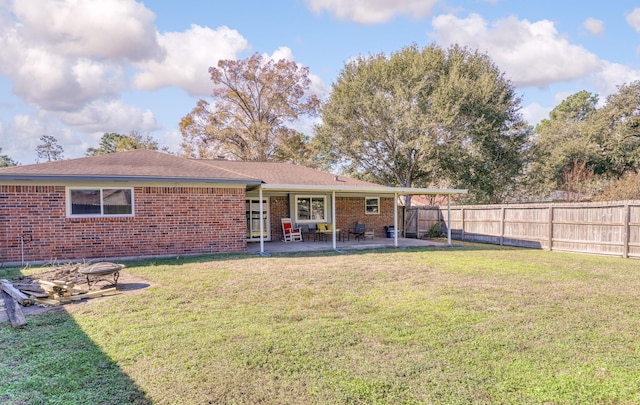 back of property featuring a patio area and a lawn