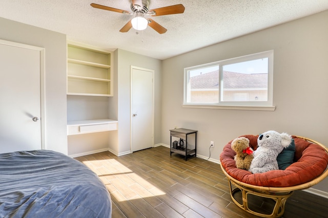 bedroom with a textured ceiling and ceiling fan