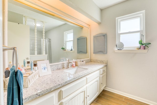 bathroom featuring vanity and curtained shower