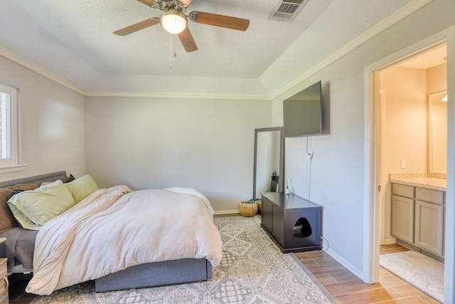 bedroom featuring connected bathroom, a textured ceiling, ornamental molding, and ceiling fan