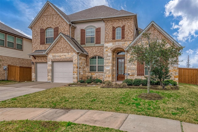 view of front of property featuring a garage and a front lawn