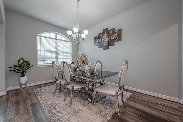 dining area featuring dark hardwood / wood-style flooring and a chandelier