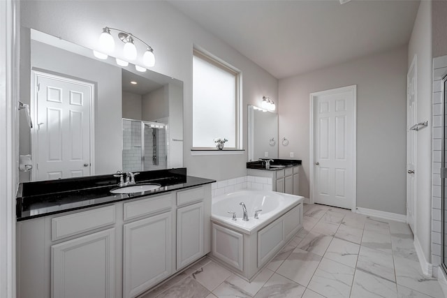 bathroom with vanity and separate shower and tub