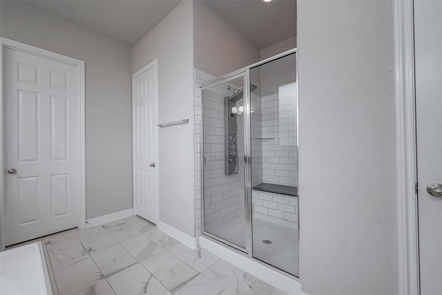 bathroom featuring a shower with door