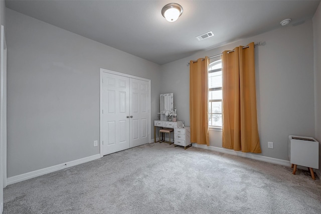 unfurnished bedroom with a closet and carpet flooring