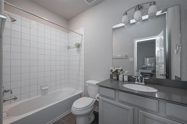 full bathroom with vanity, tile patterned flooring, toilet, and tiled shower / bath