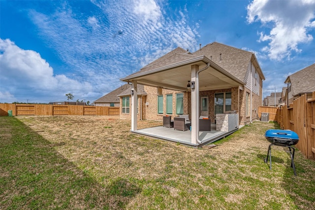 back of house with outdoor lounge area, a patio area, and a lawn