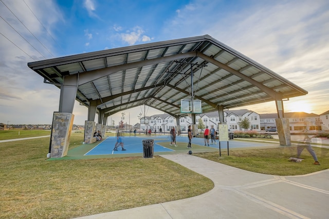 view of community with a yard and basketball hoop