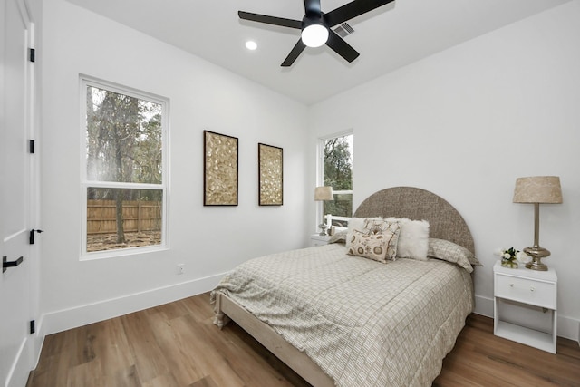 bedroom with hardwood / wood-style flooring and ceiling fan