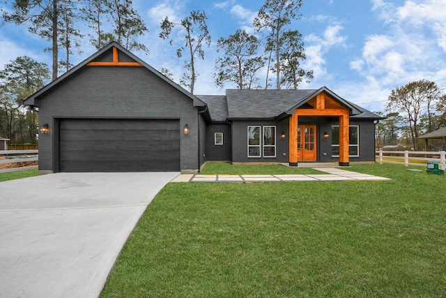 view of front of house with a garage and a front yard