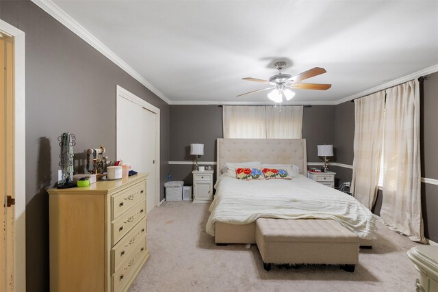 carpeted bedroom with crown molding and ceiling fan