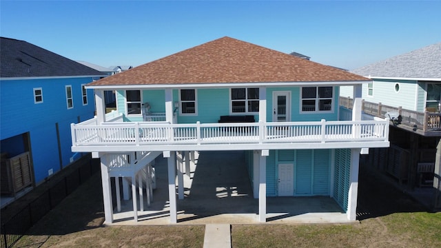 rear view of property featuring a carport and a patio