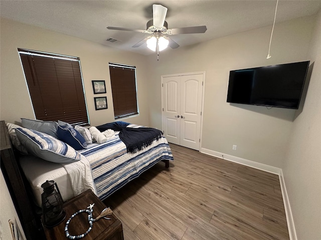 bedroom featuring wood-type flooring and ceiling fan