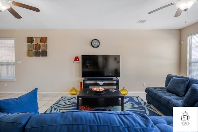 living room featuring light tile patterned floors and ceiling fan