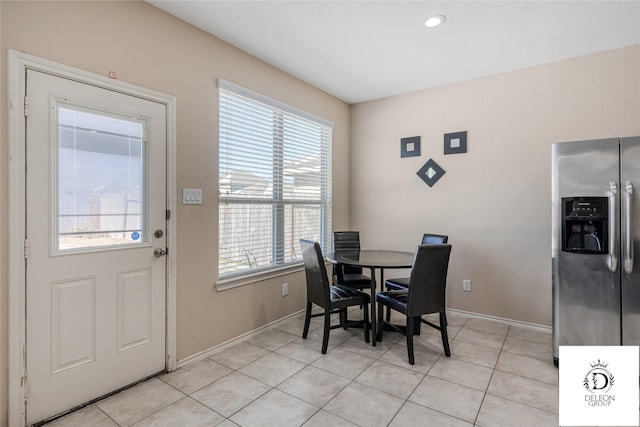 dining space featuring light tile patterned flooring