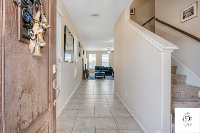 hall with light tile patterned floors