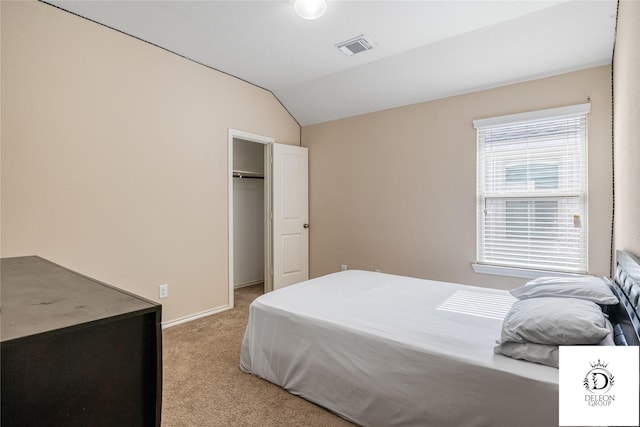 bedroom with vaulted ceiling and light colored carpet