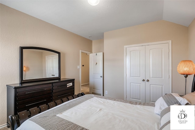 bedroom featuring vaulted ceiling and a closet