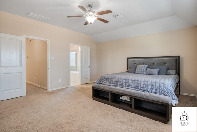 carpeted bedroom featuring vaulted ceiling, ensuite bathroom, and ceiling fan