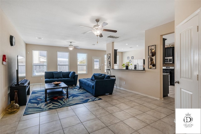 living room with ceiling fan and light tile patterned floors