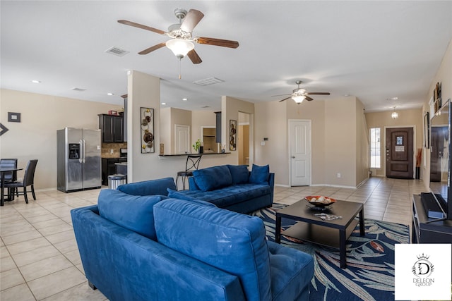 tiled living room featuring ceiling fan