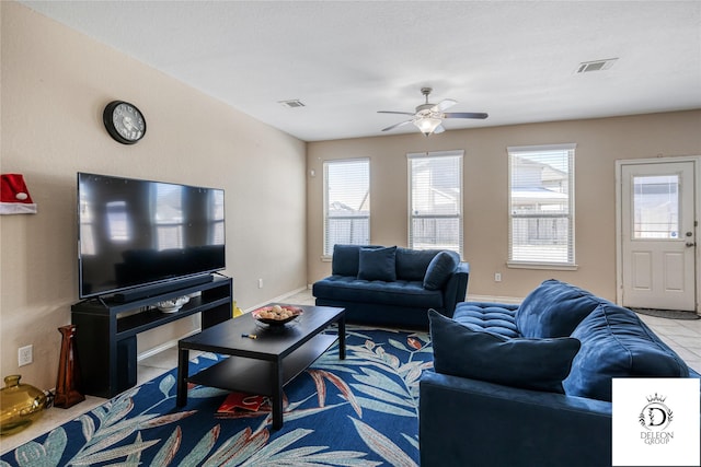 living room with ceiling fan and light tile patterned floors