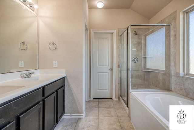 bathroom featuring tile patterned floors, independent shower and bath, vaulted ceiling, and vanity