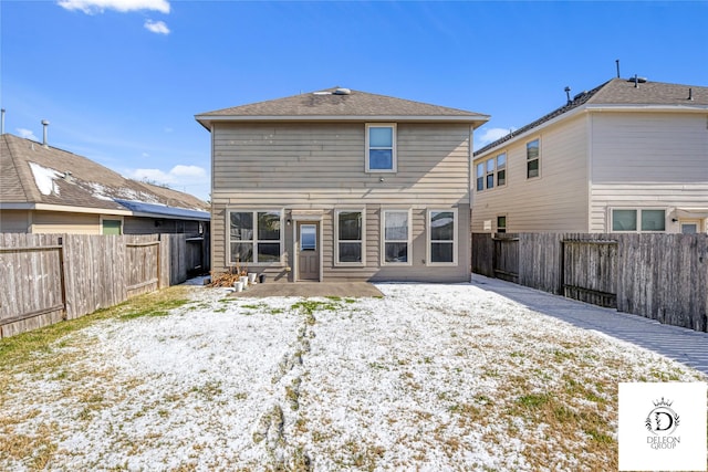 snow covered rear of property featuring a patio area