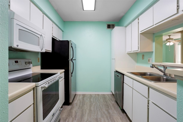 kitchen with sink, white cabinetry, ceiling fan, white appliances, and light hardwood / wood-style floors