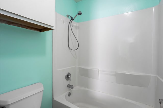 bathroom featuring tub / shower combination and toilet