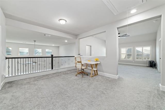 carpeted home office with ceiling fan