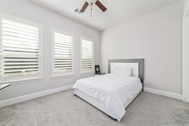 bedroom featuring light carpet and ceiling fan