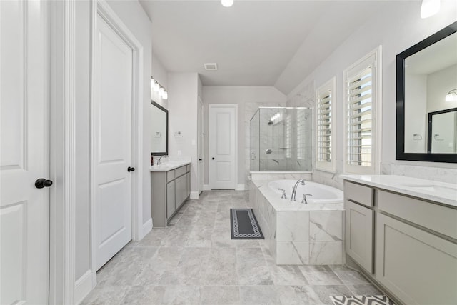 bathroom with vanity and independent shower and bath