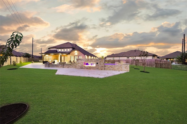 playground at dusk with a patio and a yard