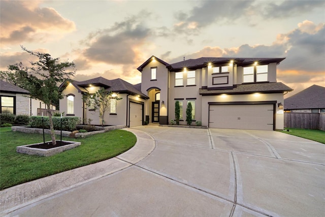 view of front of house featuring a yard and a garage