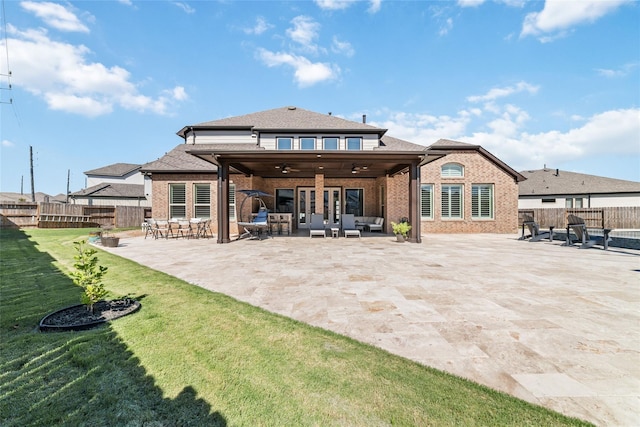 rear view of house with a lawn, outdoor lounge area, a patio, and ceiling fan