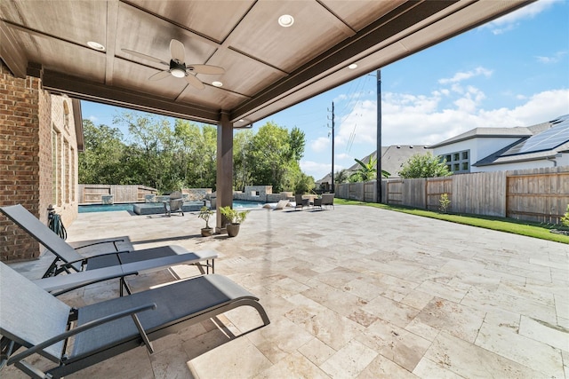 view of patio / terrace with a fenced in pool and ceiling fan