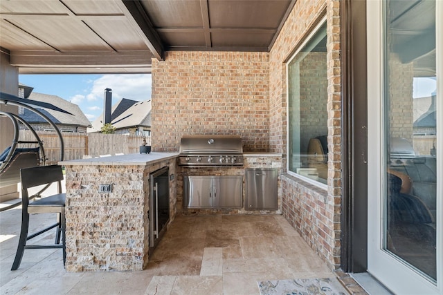 view of patio / terrace with an outdoor kitchen, exterior bar, and area for grilling