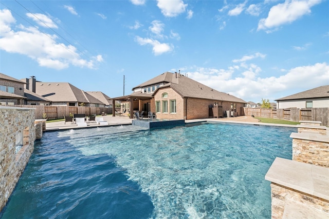 view of swimming pool with a water view and a patio area