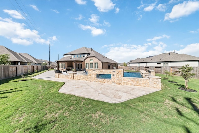 back of house featuring a fenced in pool, a patio, and a yard