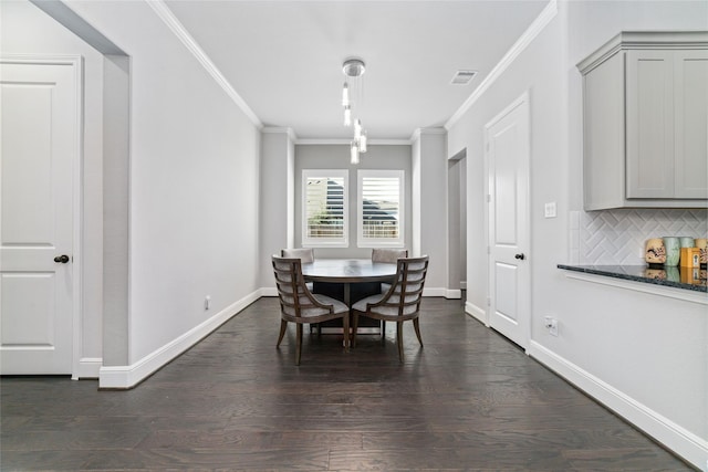 dining room featuring ornamental molding and dark wood-type flooring