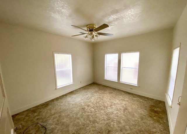 unfurnished room featuring ceiling fan and carpet flooring