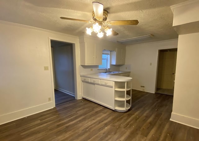 kitchen featuring sink, ceiling fan, dark hardwood / wood-style floors, a textured ceiling, and white cabinets