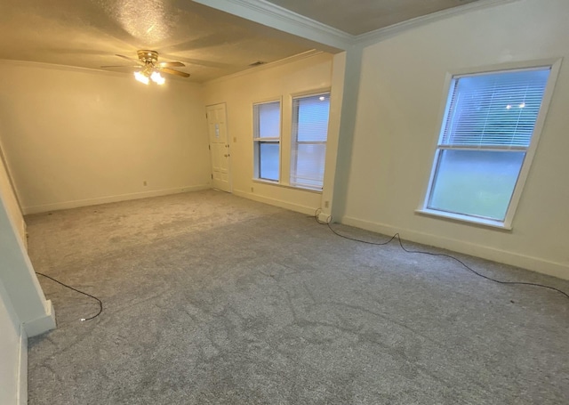 carpeted spare room with crown molding and ceiling fan