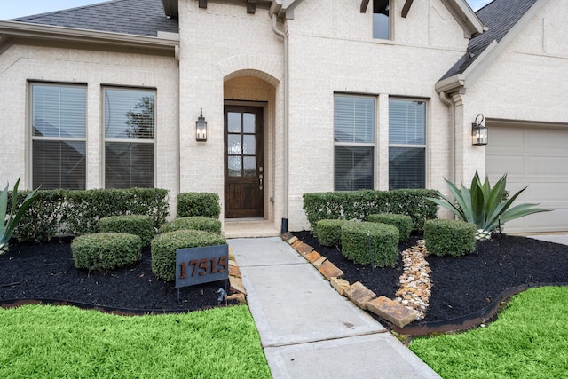 doorway to property with a garage