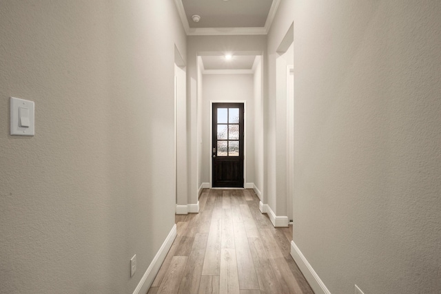 hall featuring crown molding and light hardwood / wood-style flooring